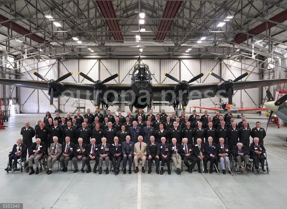 UK King Charles III visit to Lincolnshire 24 July 2023, United Kingdom, Coningsby: UK King Charles III poses for a photograph with staff and World War Two veterans, during a visit to the Battle of Britain Memorial Flight (BBMF) in Coningsby, to commemorate the 80th anniversary of Operation Chastise. Photo: Arthur Edwards/The Sun via PA Wire/dpa