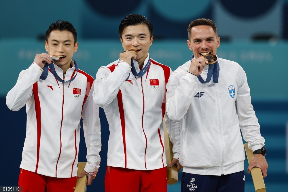 Artistic Gymnastics - Olympics Games Paris 2024: Day 9 Silver medalist Jingyuan Zou of China, Gold medalist Yang Liu Team China and Bronze medalist Eleftherios Petrounias of Greece pose on the podium during Men's Rings Final of the Artistic Gymnastics on Bercy Arena during the Paris 2024 Olympics Games on August 4, 2024 in Paris, France.