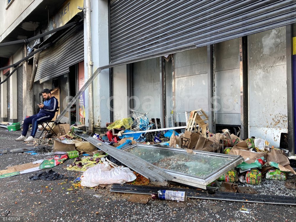 UK Riots: Supermarket destroyed in Belfast 06 August 2024, United Kingdom, Belfast: Abdelkader Mohamad Al Alloush, owner of the Sham Supermarket sits outsude his destroyed shop on Donegall Road in Belfast. The shop was burned during disorder in the area following an anti-immigration protest on Saturday. Another attempt was made to burn it during the disorder on Monday night. Photo: Rebecca Black/PA Wire/dpa