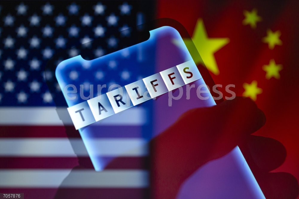 US Raises China Tariffs To 125 Percent April 9, 2025, Asuncion, Paraguay: The word ''Tariffs'' is displayed on a smartphone backdropped by cropped flags of the United States and China. U.S. President Donald J. Trump raised the tariff on Chinese imports to 125% on Wednesday.