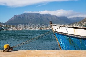 A boat sits docked on the water in Hout Bay in Cape Town, South Africa
